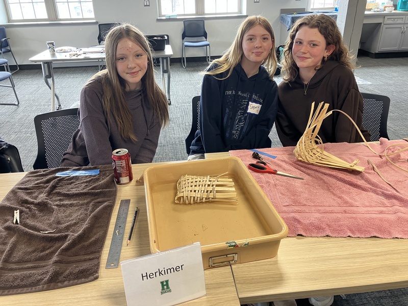 Students posing while working on baskets