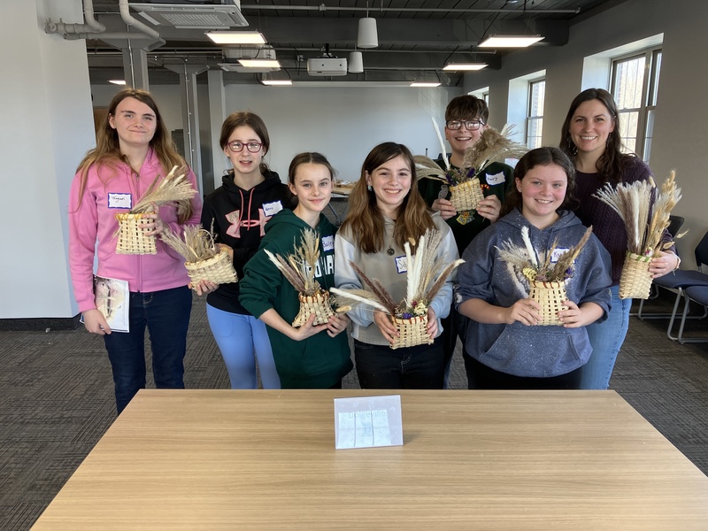 Students and staff member posing with baskets