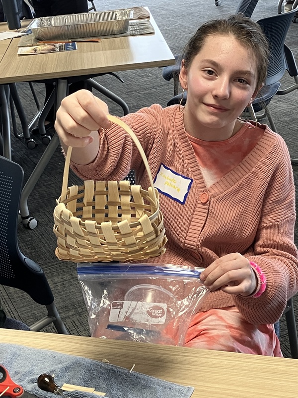 Student holding up a basket