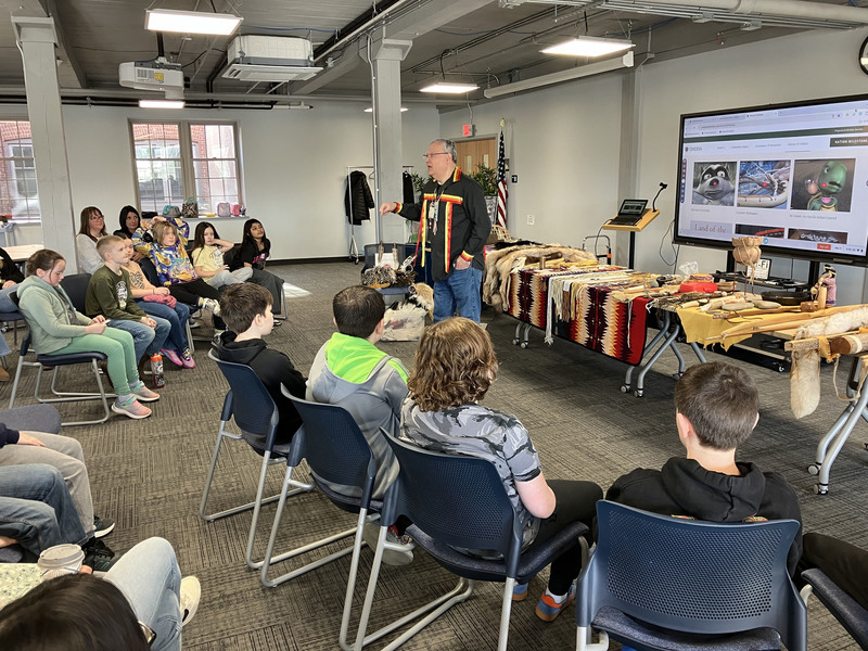 Randy Phillips presenting to local fourth graders with Iroquois items displayed