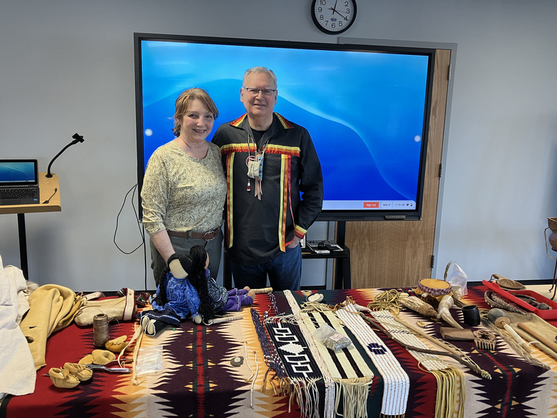 Randy Phillips and another person posing with Iroquois items