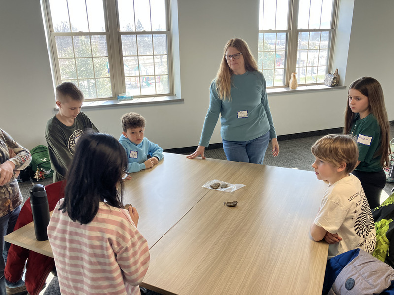Students and others around a table