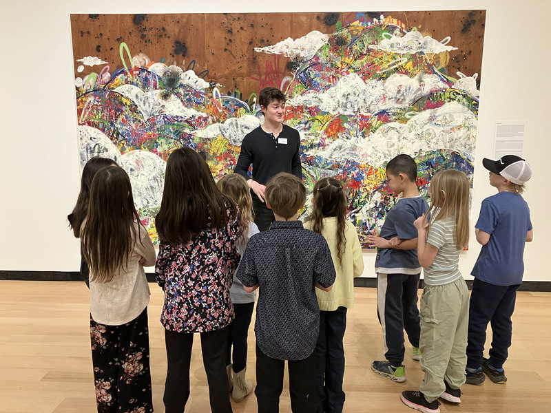 Students and a guide looking at art at Wellin Museum