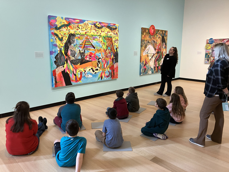 Students and a guide looking at art at Wellin Museum