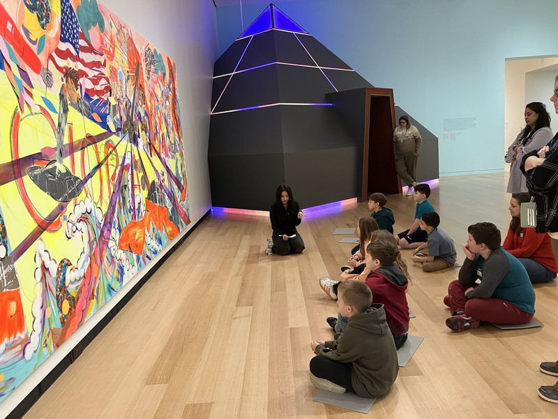 Students and a guide looking at art at Wellin Museum