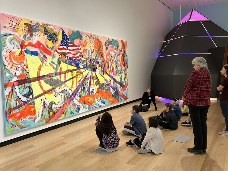 Students and a guide looking at art at Wellin Museum