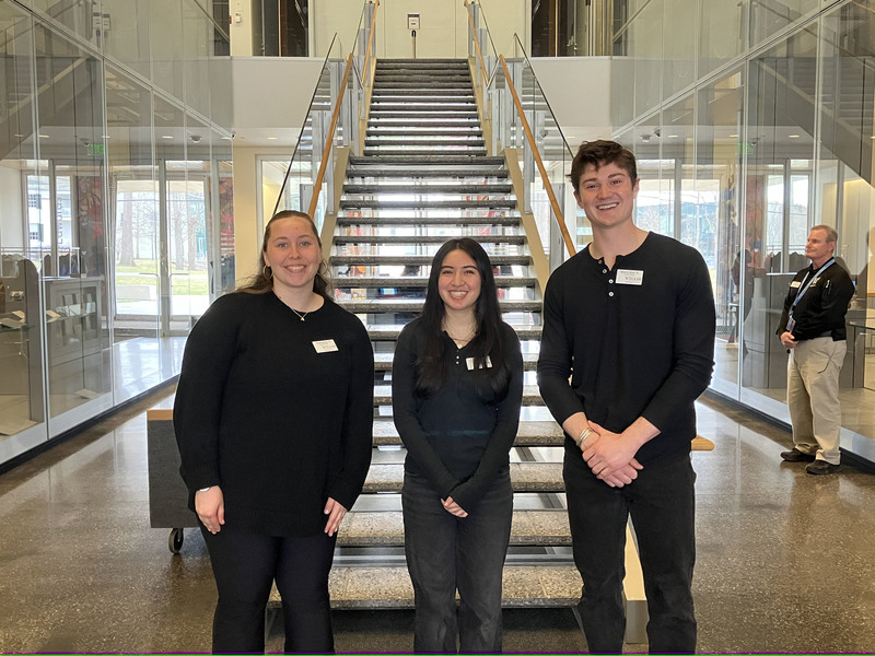 Art museum staff members in front of stairs
