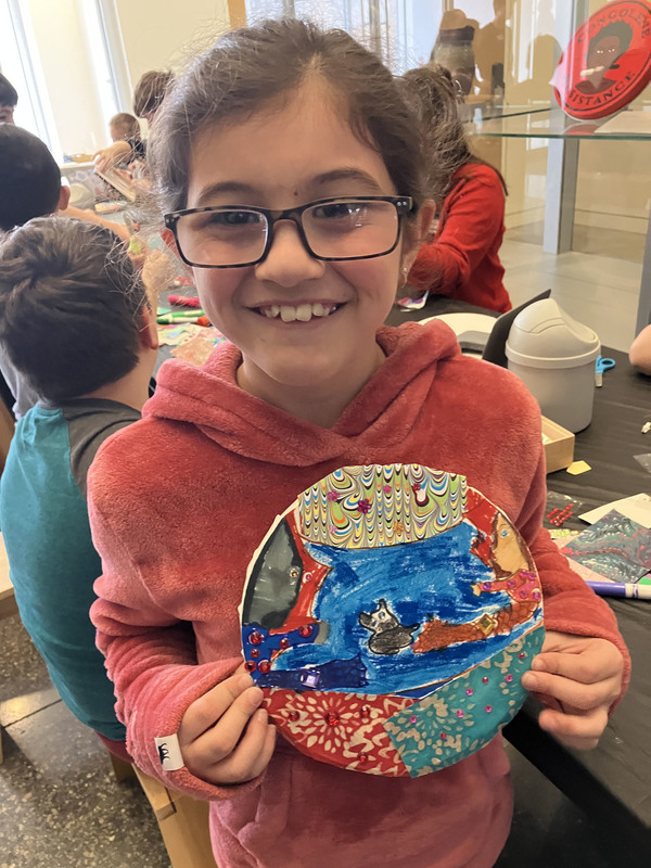 Student displaying artwork at art musem