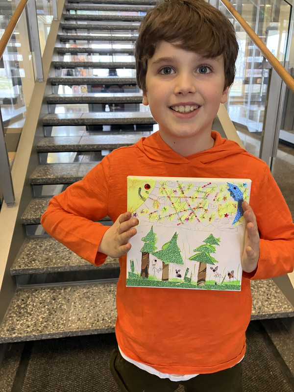 Student displaying artwork at art musem