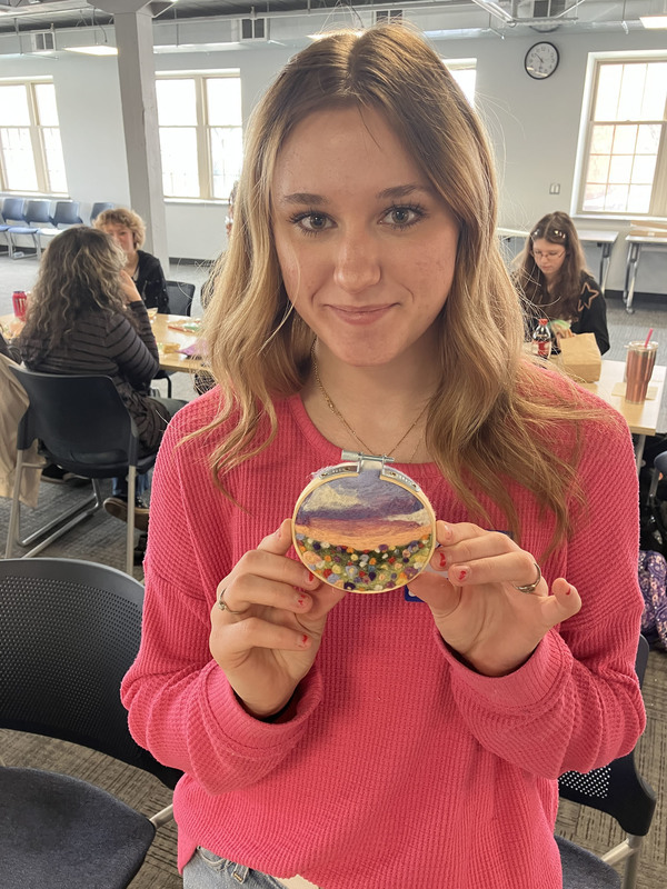 Student posing with needle felting work
