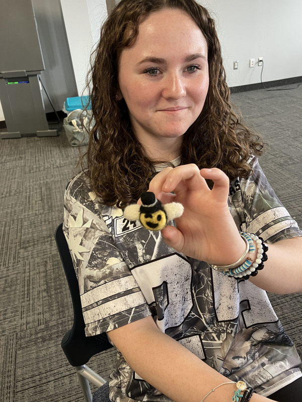 Student posing with needle felting work