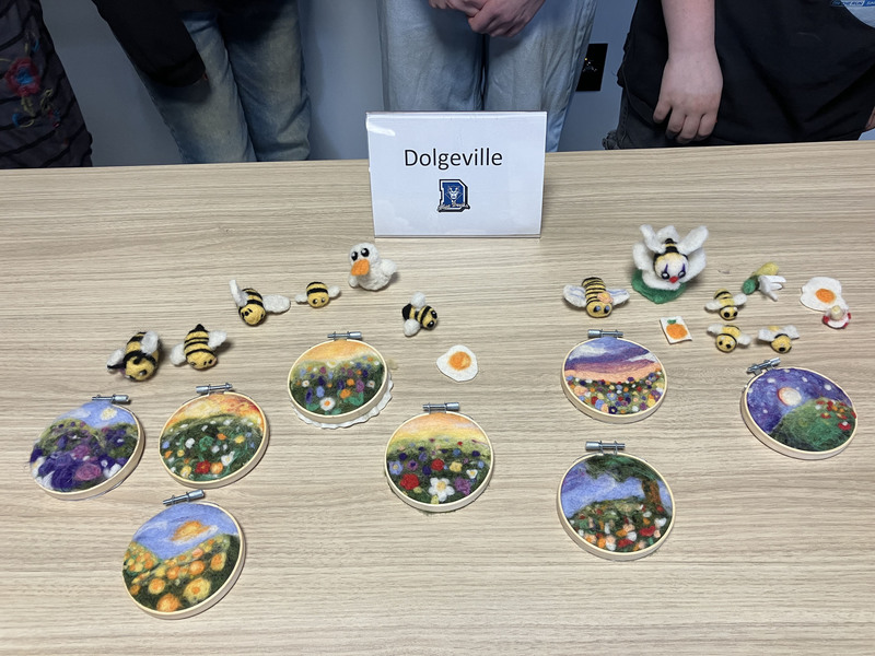 Needle felting work displayed on a table