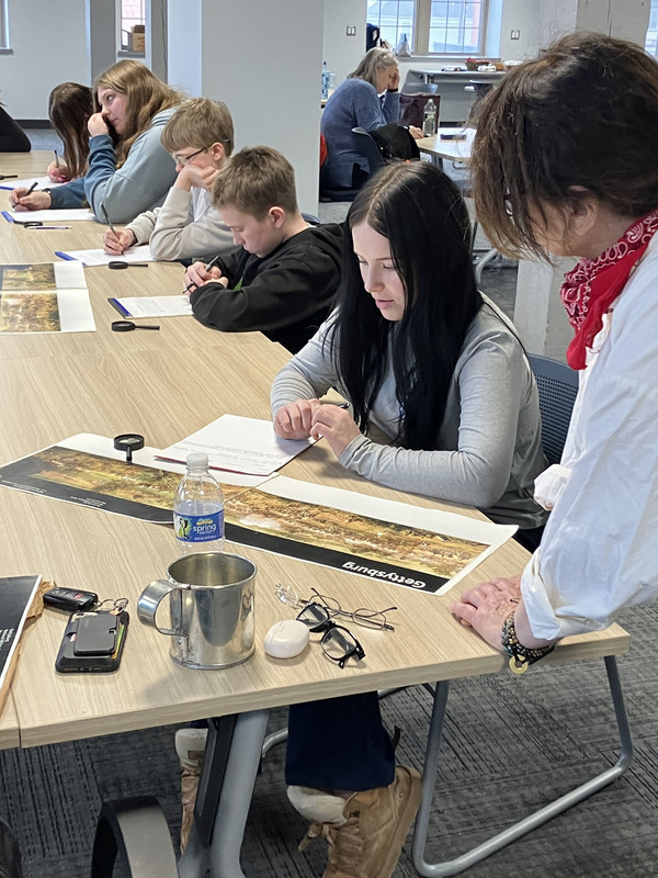 People sitting at tables during Civil War workshop and presentations