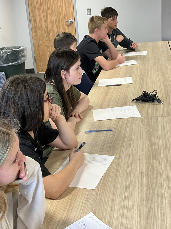 People sitting at tables during Civil War workshop and presentations