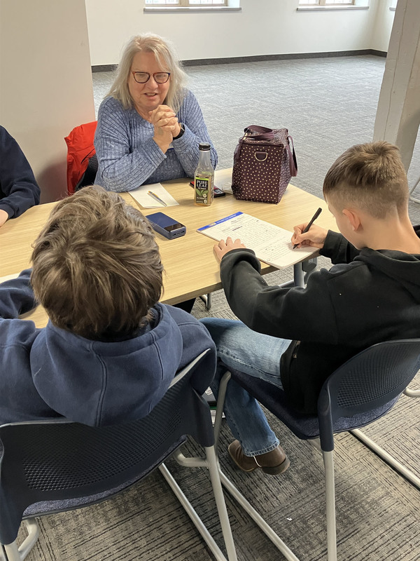 People sitting at tables during Civil War workshop and presentations