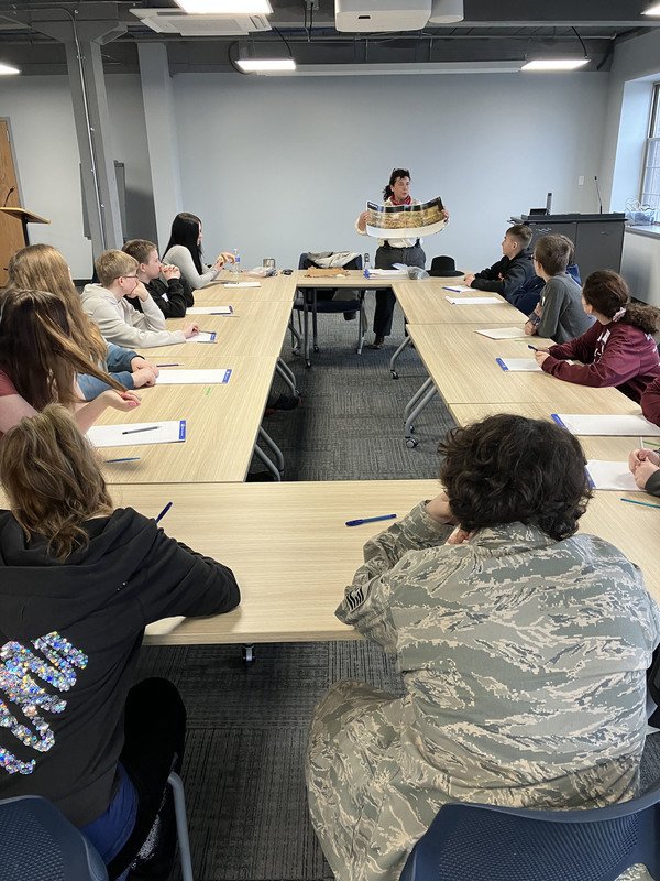 People sitting at tables during Civil War workshop and presentations