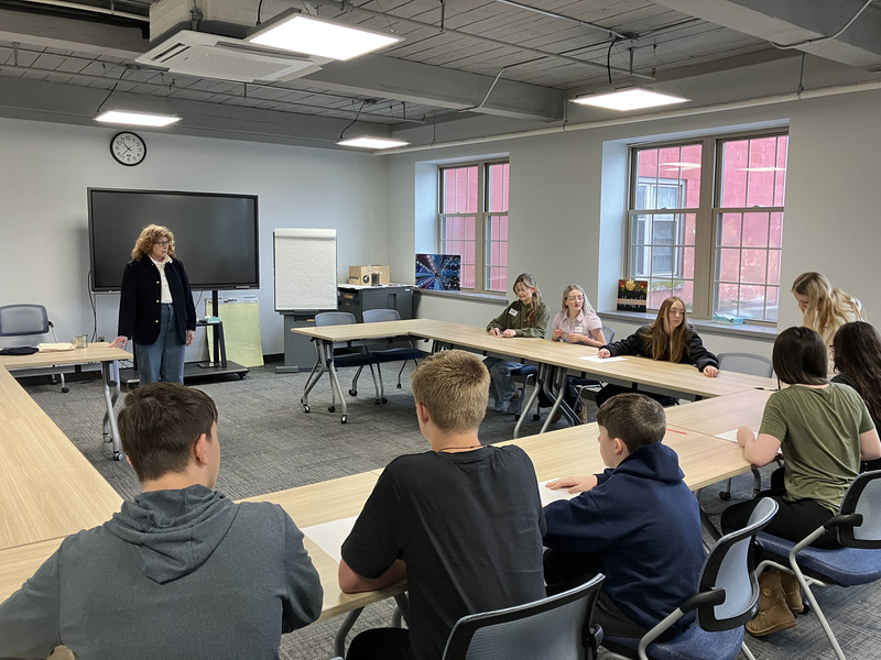 People sitting at tables during Civil War workshop and presentations