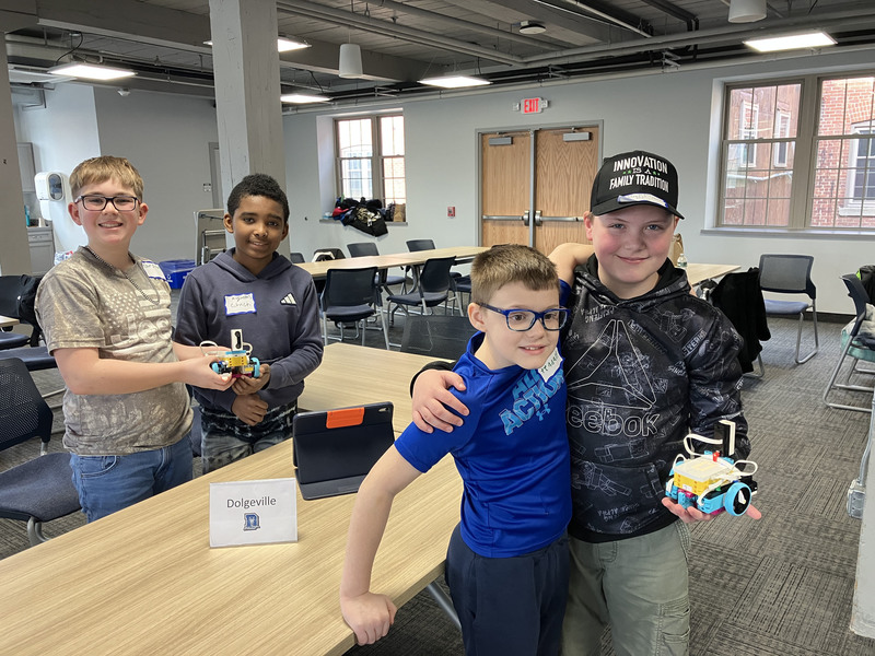 Students at table with robots