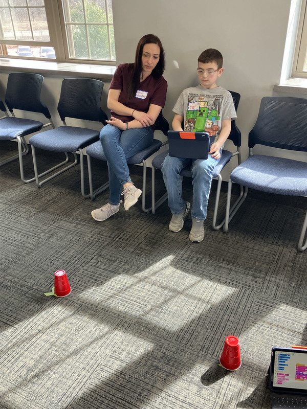 Student and staff member using tablet