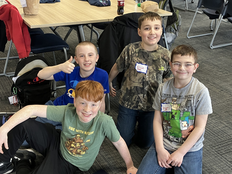 Students on floor posing for a photo