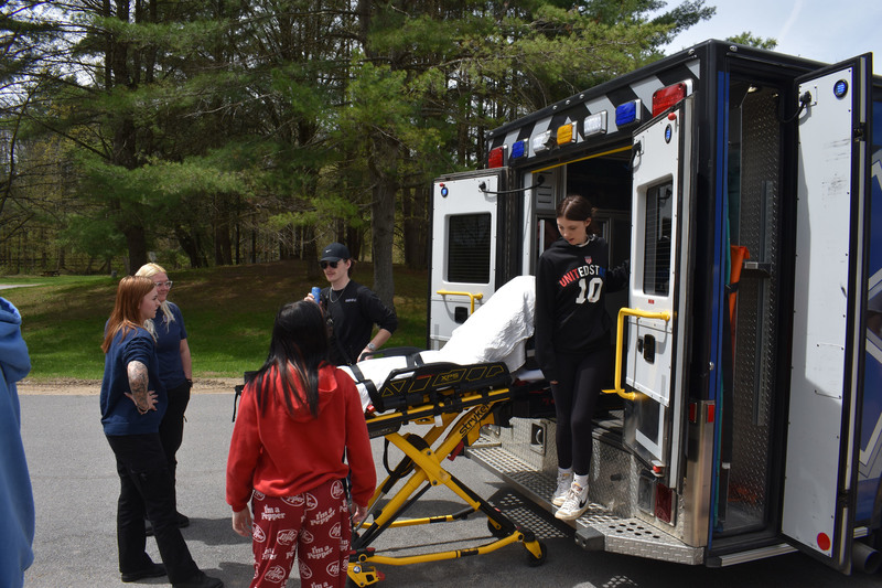 Students and MOVAC employees touring back of an ambulance