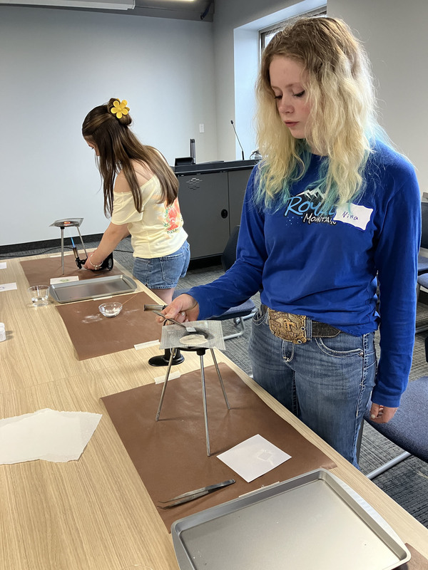Two students working on art/jewelry project