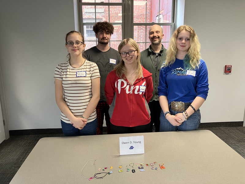 Five people posing with jewelry they made