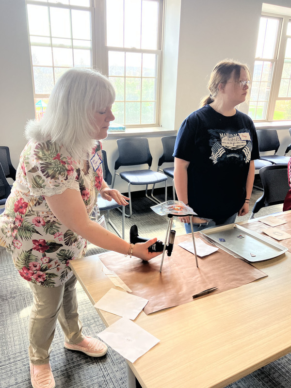 Two people working on art/jewelry project