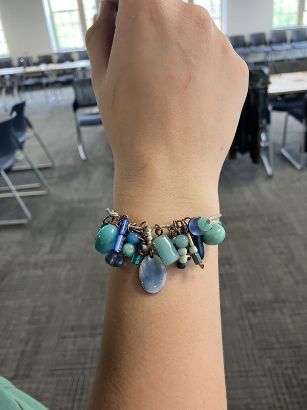 A blue and aqua bracelet with many shapes