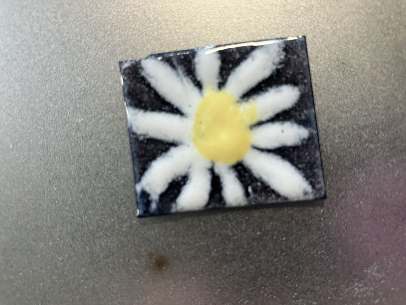 Piece of artwork with a flower on it