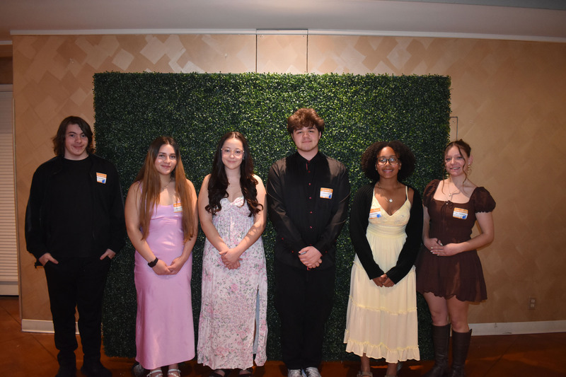 Six students posing together at awards event