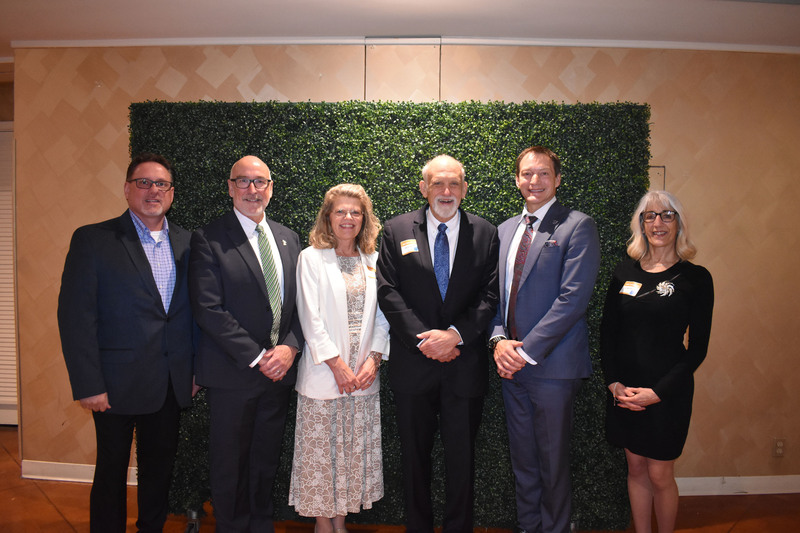 Six school officials posing together at awards event
