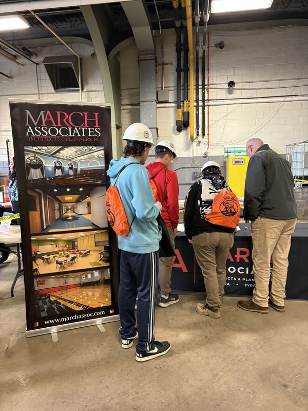 Students looking at March Associates display