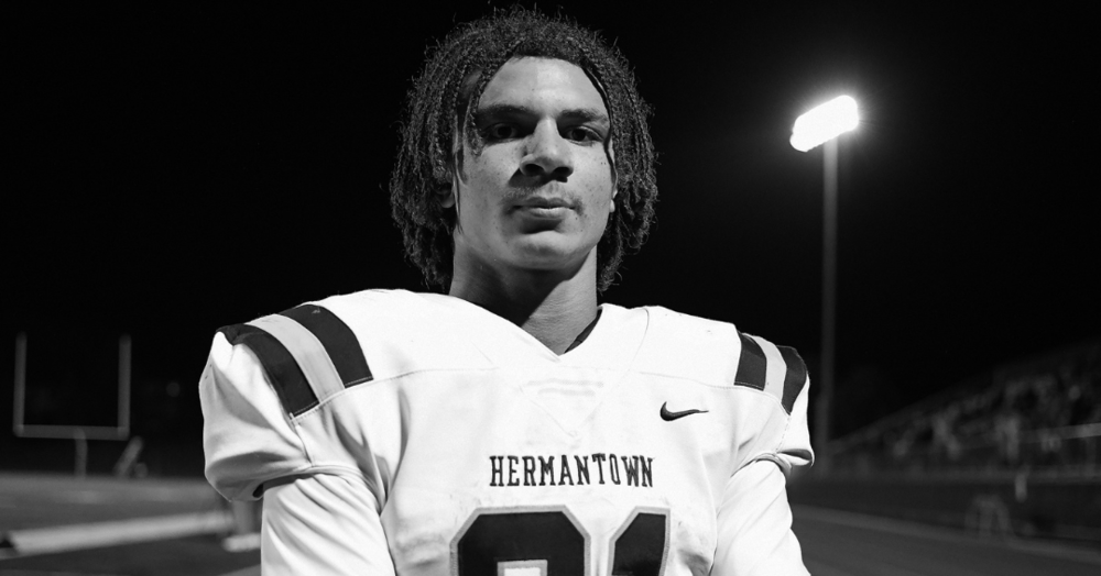 Martin Sleen standing with arms folded in black and white