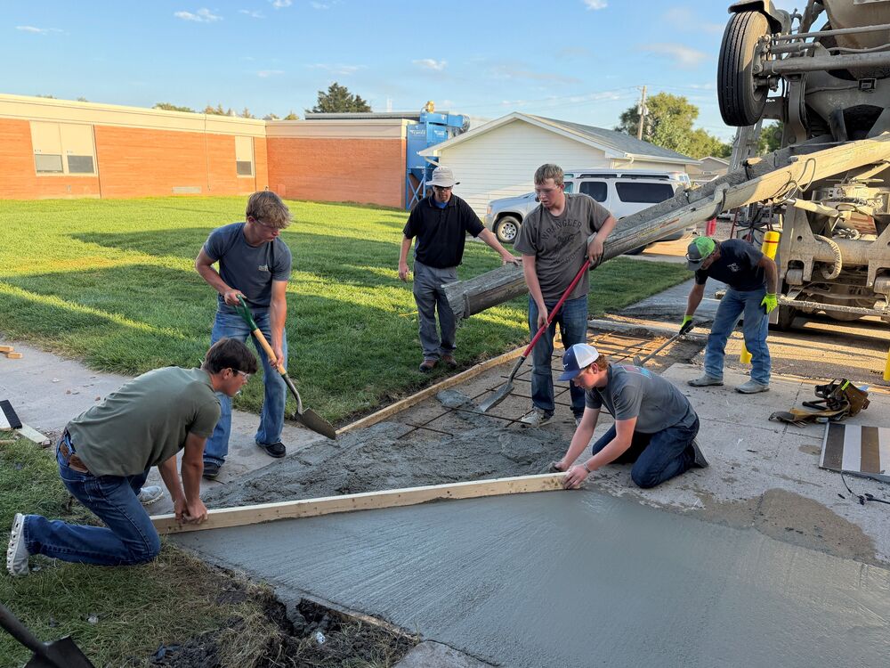 construction class pours and levels concrete