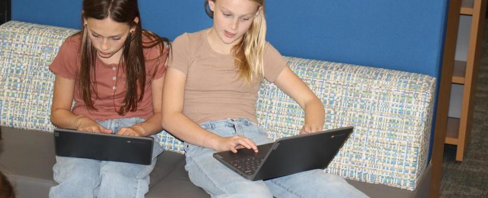 “Students at Hershey Public Schools working together on laptops during a digital citizenship lesson about responsible use of artificial intelligence.”