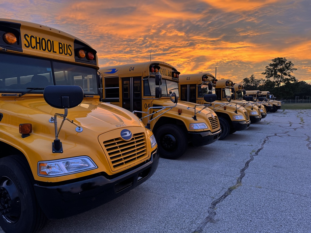 Busses under a sunrise