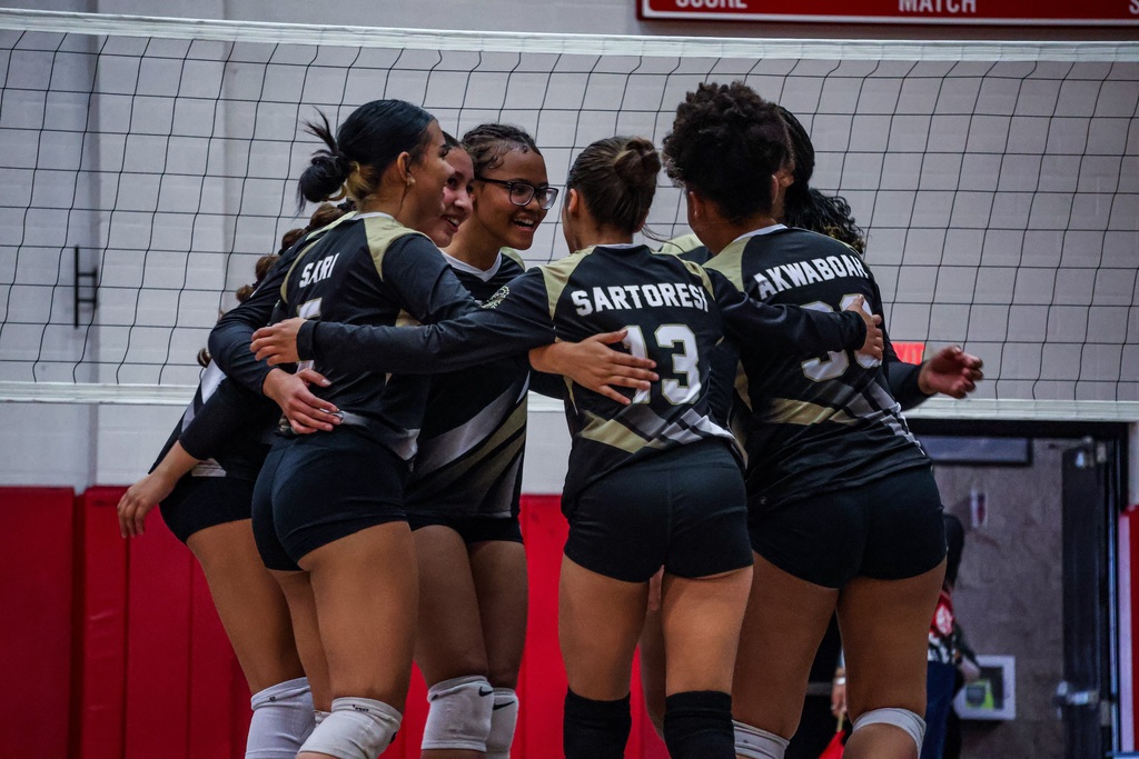 HHS volleyball players celebrate a point