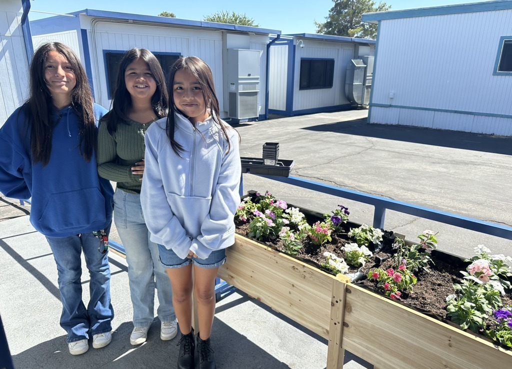 students planting flowers