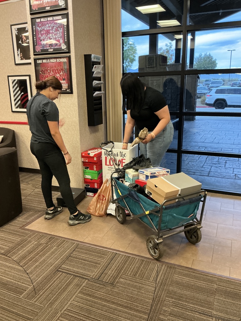 students packing up the donated shoes