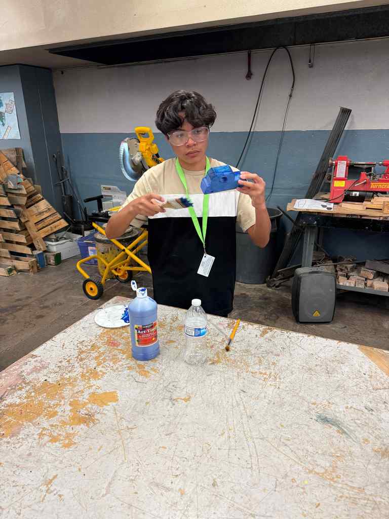 students in class working on wooden cars