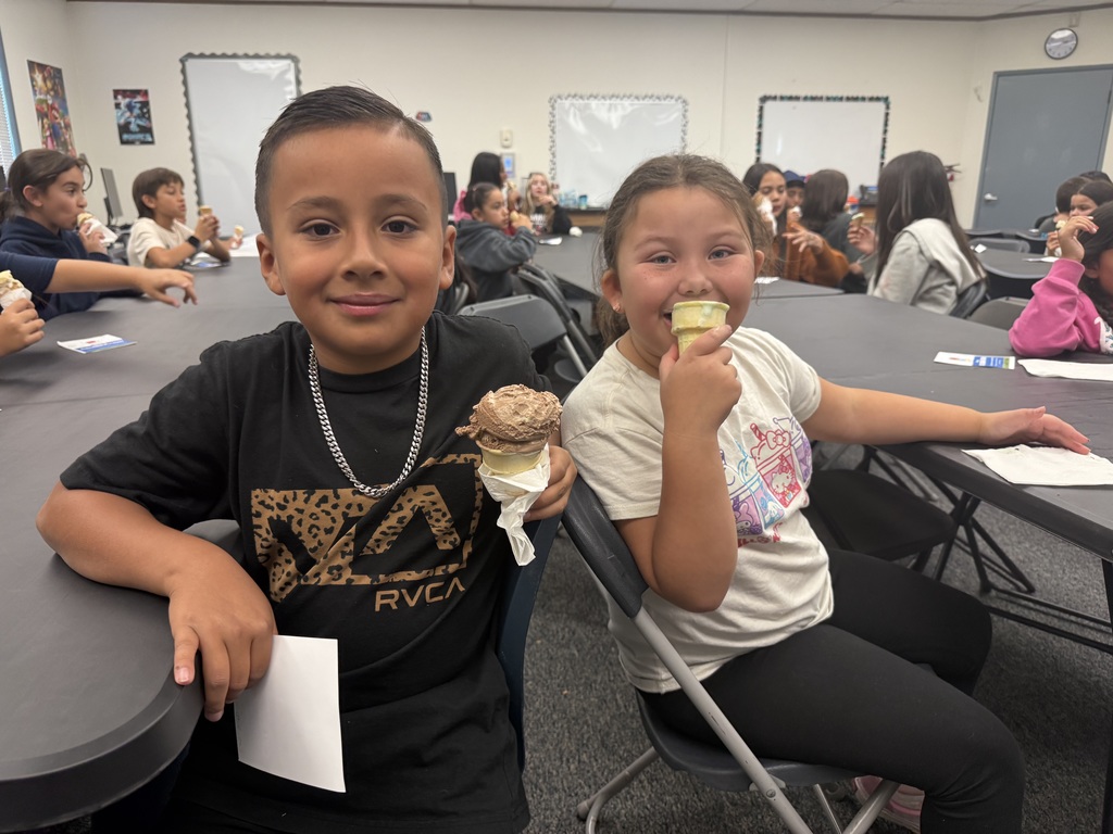 Two students enjoying an ice cream cone for their iReady reward!