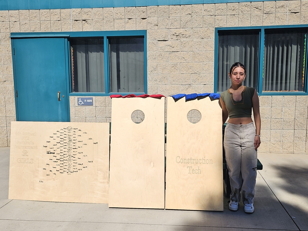 Students and staff competing in cornhole competition