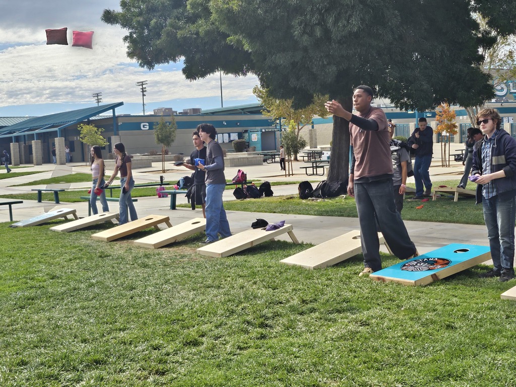 Students and staff competing in cornhole competition