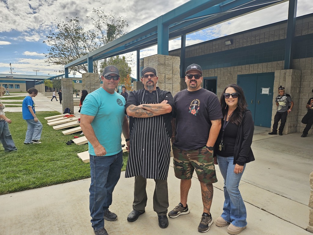 Students and staff competing in cornhole competition