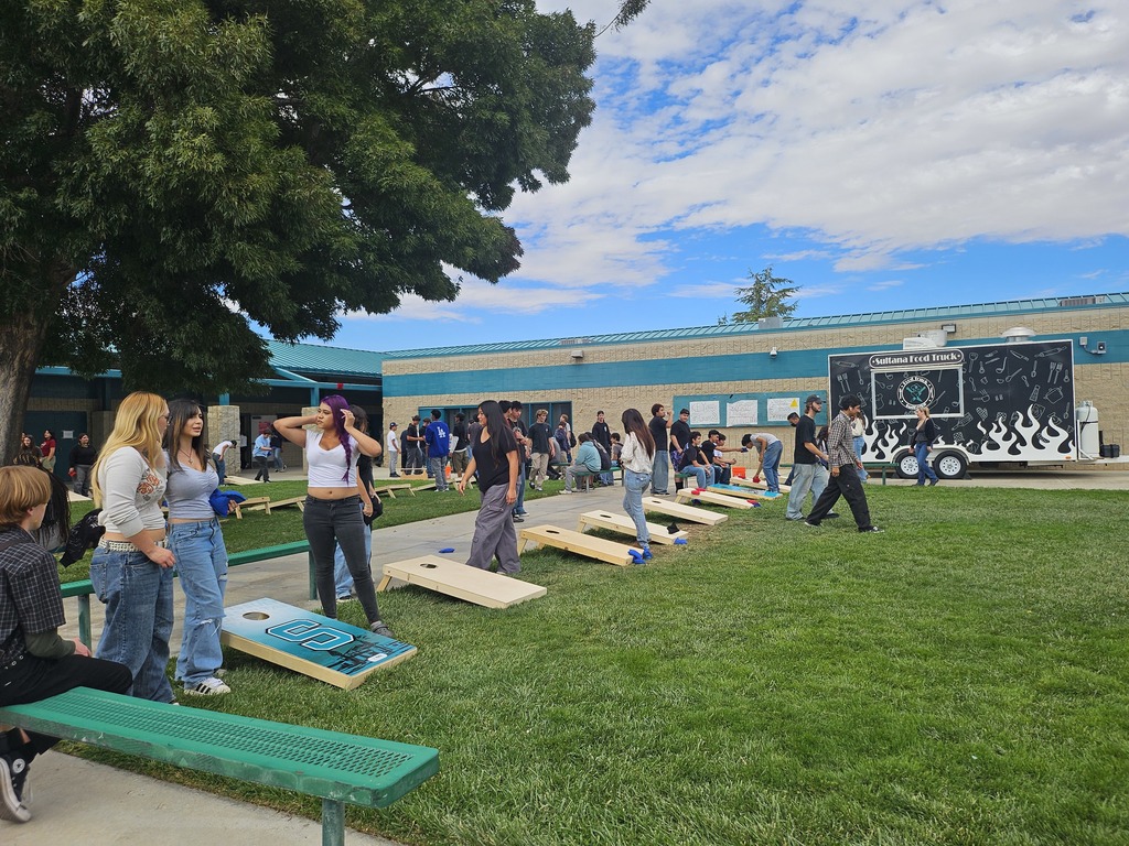 Students and staff competing in cornhole competition
