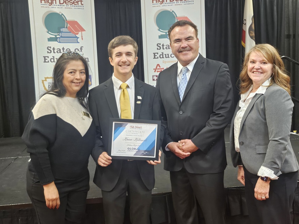 Picture of Kaine with board member, county, and district superintendent at banquet