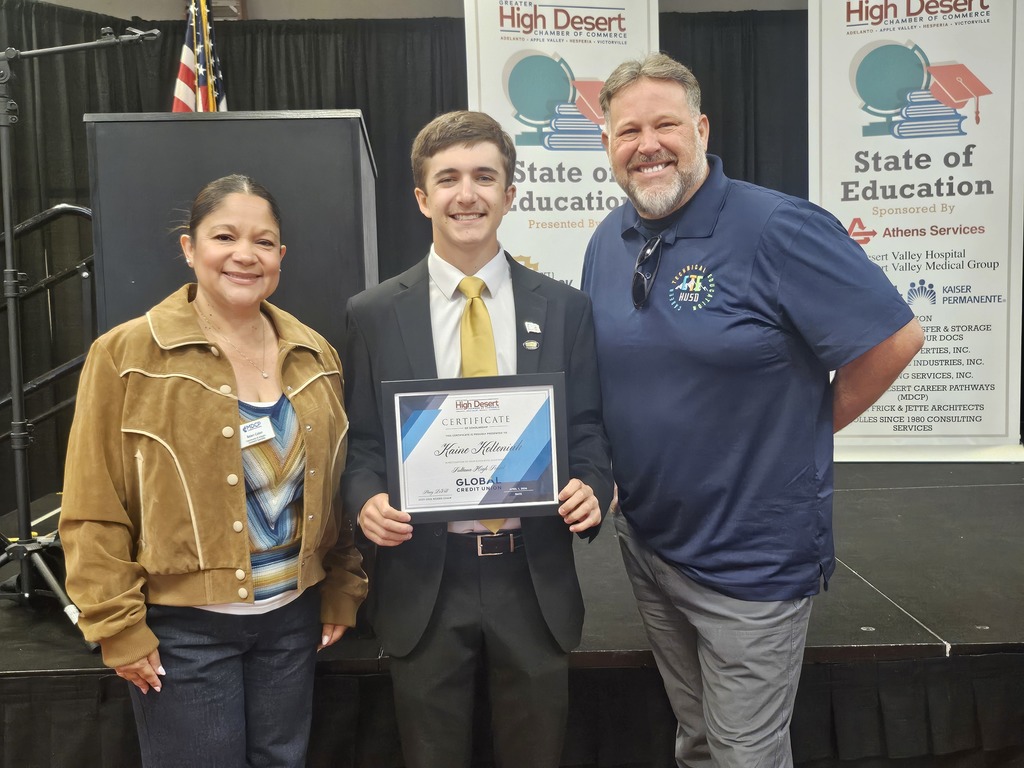 Picture of Kaine with admin at banquet