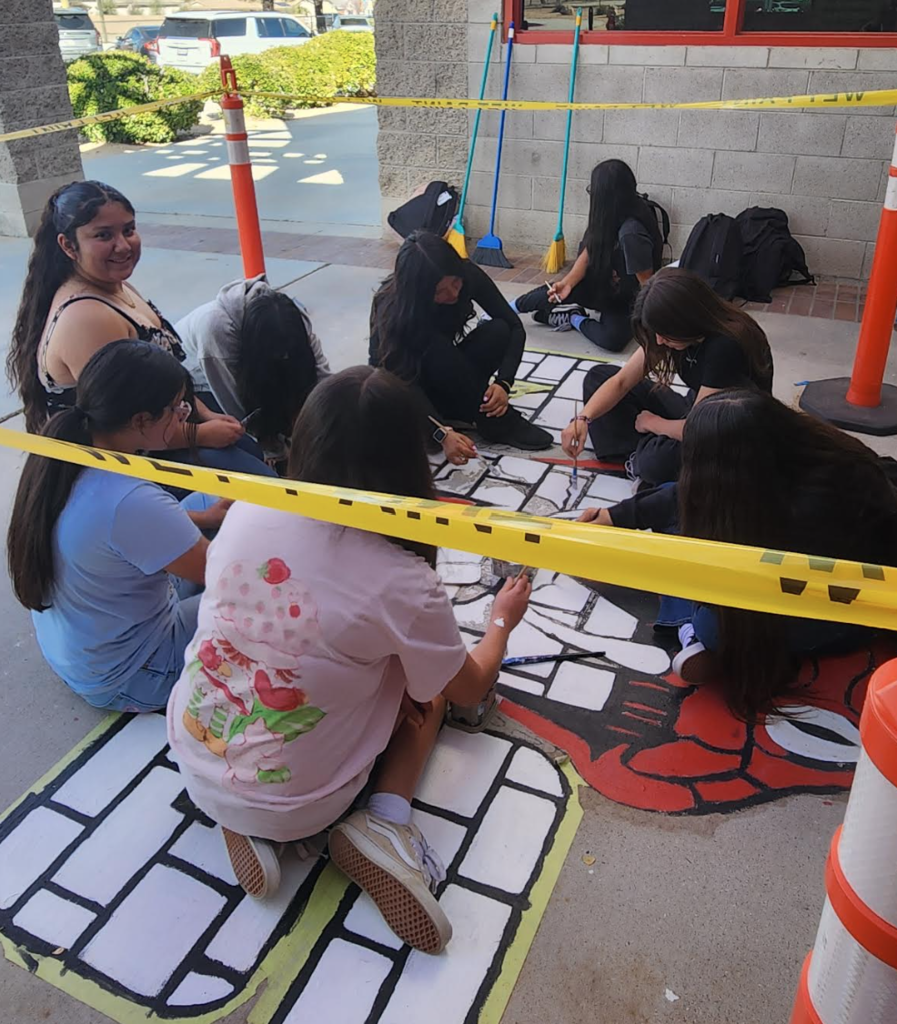 art students painting mural