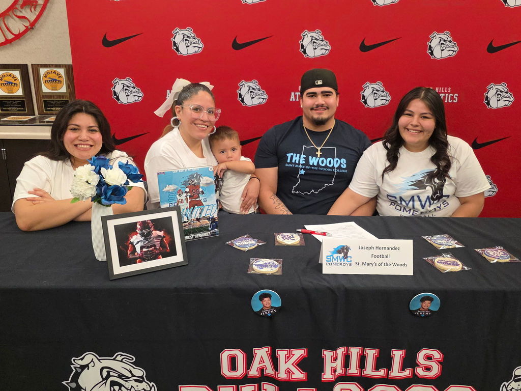 Oak Hills High School proudly celebrates one of its finest as star football standout Joseph “Moose” Hernandez takes the next step in his journey, signing with St. Mary’s of the Woods!  A true force on the field, Moose was a cornerstone of Bulldog football, bringing power, grit, and relentless determination every Friday night. His impact helped drive Oak Hills to an incredible milestone: the program’s 5th consecutive Mojave River League Championship, cementing his legacy as part of a dominant era.  Moose, your hard work, leadership, and passion have set the standard. The entire Bulldog community is behind you as you head to Indiana to continue your academic and athletic career.  It's a great day to be a Bulldog!